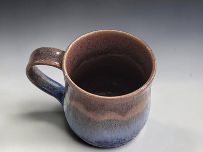 internal view of a Handmade pottery mug showing natural layered glaze variations