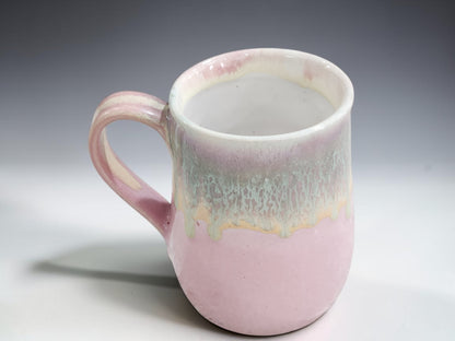 Handmade pottery mug in soft pink with layered green and cream glaze, Melbourne Australia