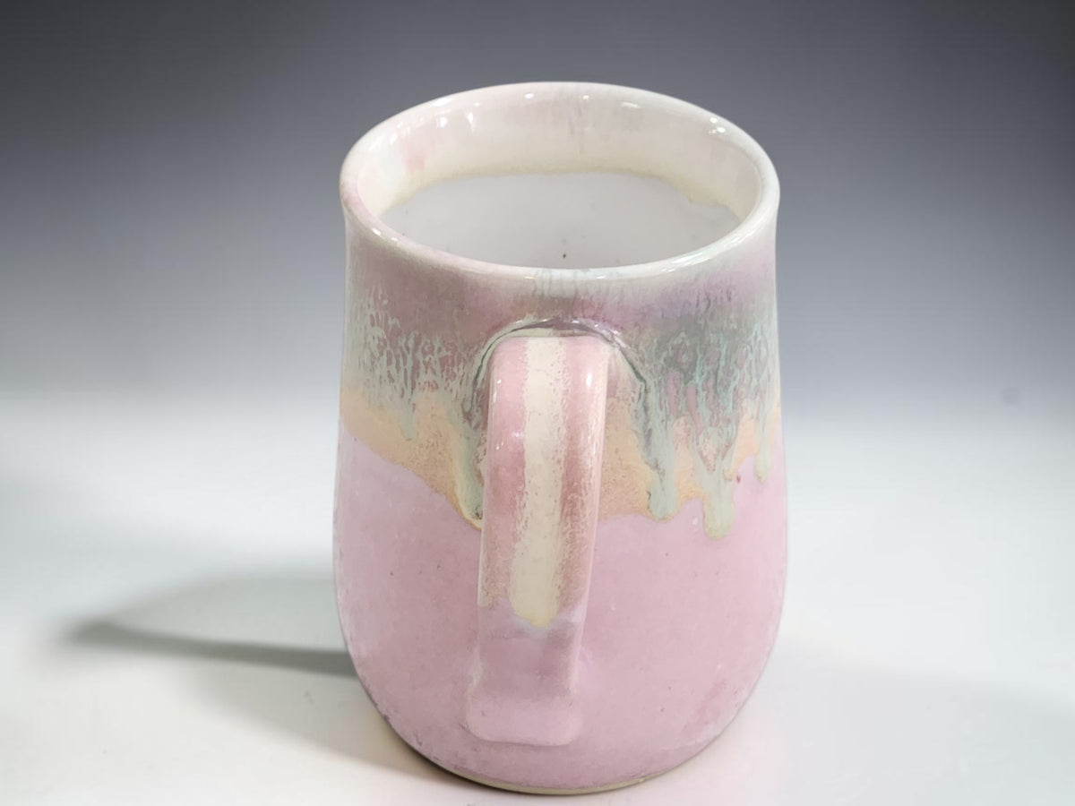 Australian handmade pottery mug with soft pink and layered natural glaze colours