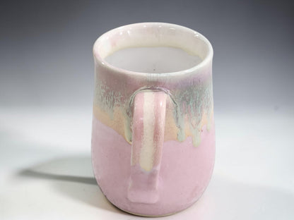 Australian handmade pottery mug with soft pink and layered natural glaze colours