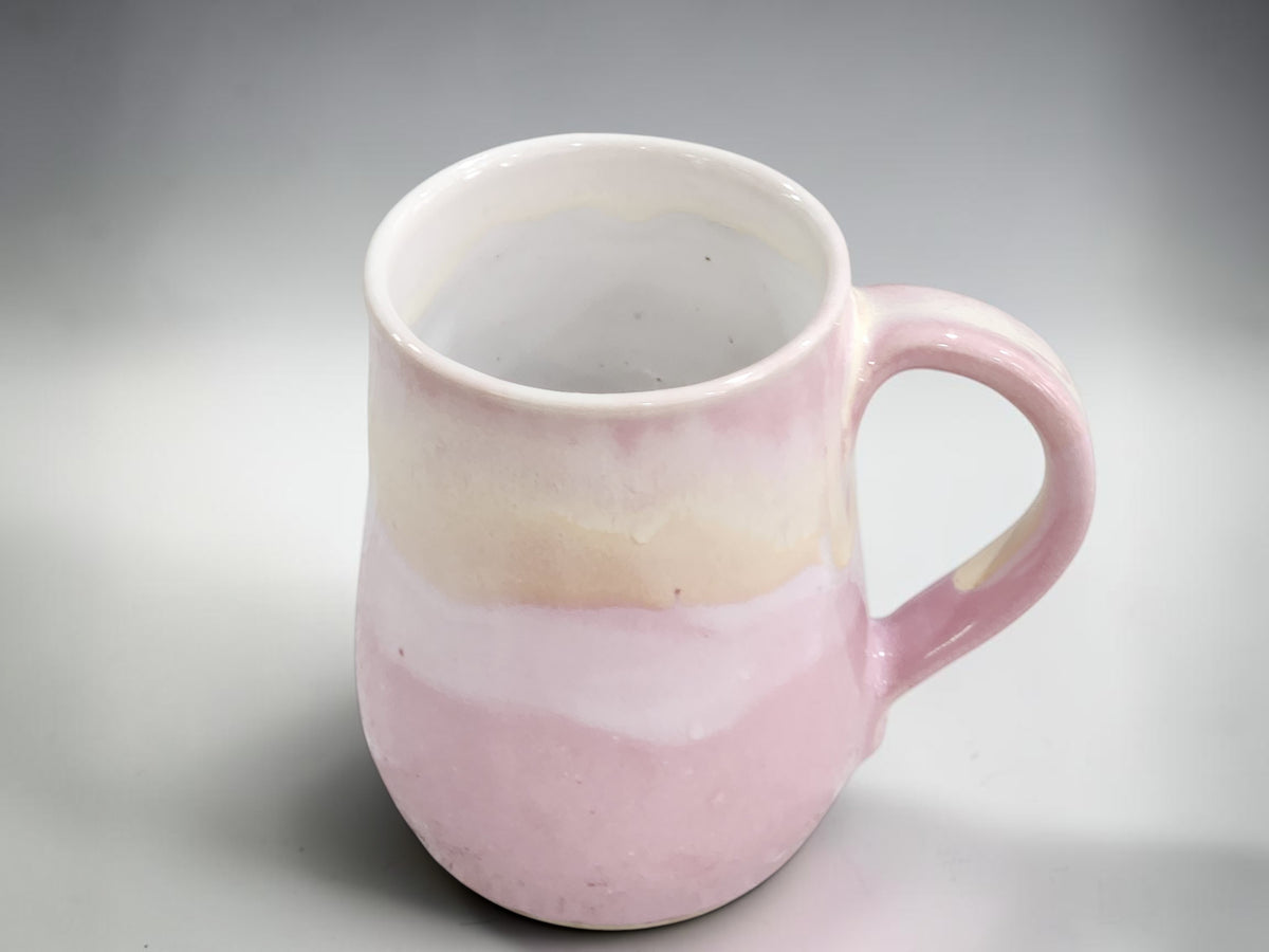 Soft pink handmade stoneware mug with layered cream glaze by Buxton Pottery