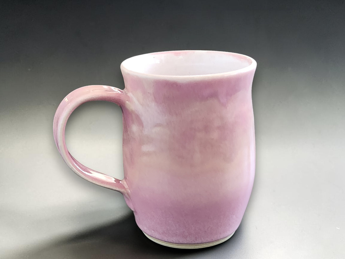 Pink handmade ceramic mug with soft variegated glaze
