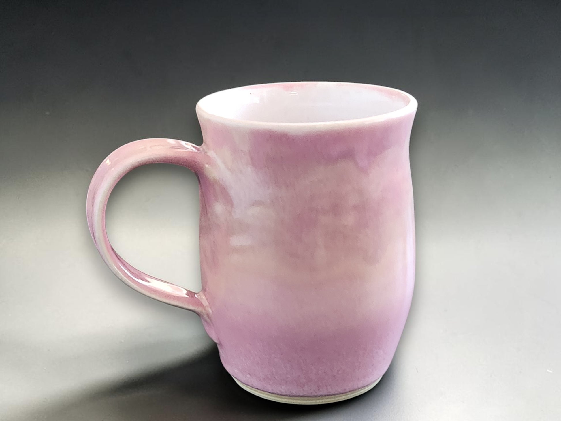 Pink handmade ceramic mug with soft variegated glaze