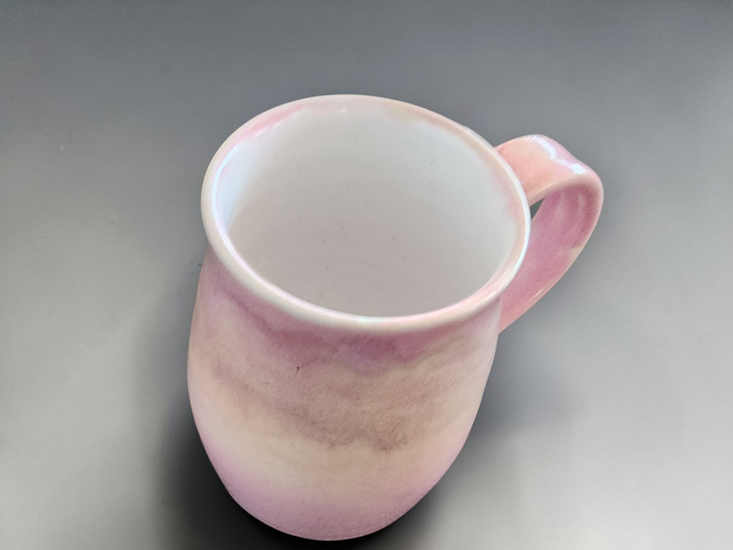 Pink handmade mug with glossy finish and organic shape