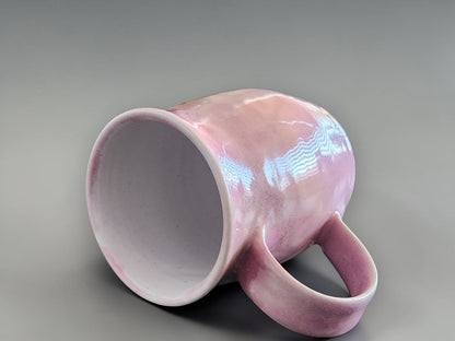 Handmade pink pottery mug with curved handle