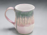 Australian handmade pottery mug with soft pink and sage green glaze