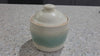A  handmade potteru sugar bowl in cream and green glaze