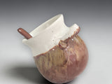 Small pottery salt pig with angled opening and wooden spoon