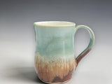 Handmade mug with layered green, cream and brown glaze
