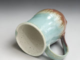 Tall handmade ceramic mug with elegant curved shape