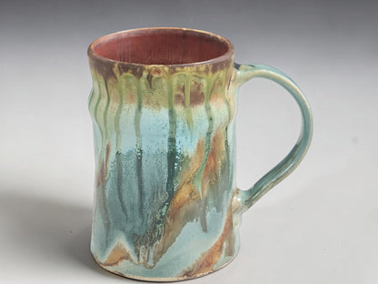 Handmade stoneware coffee mug with flowing sage green and sandstone glaze