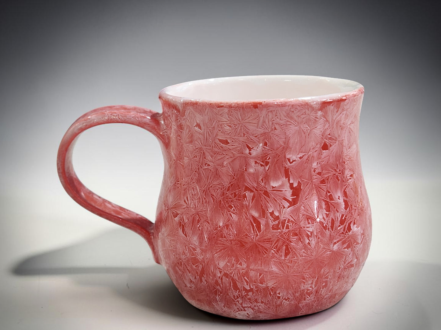 Red crystalline mug with contrasting light glazed interior