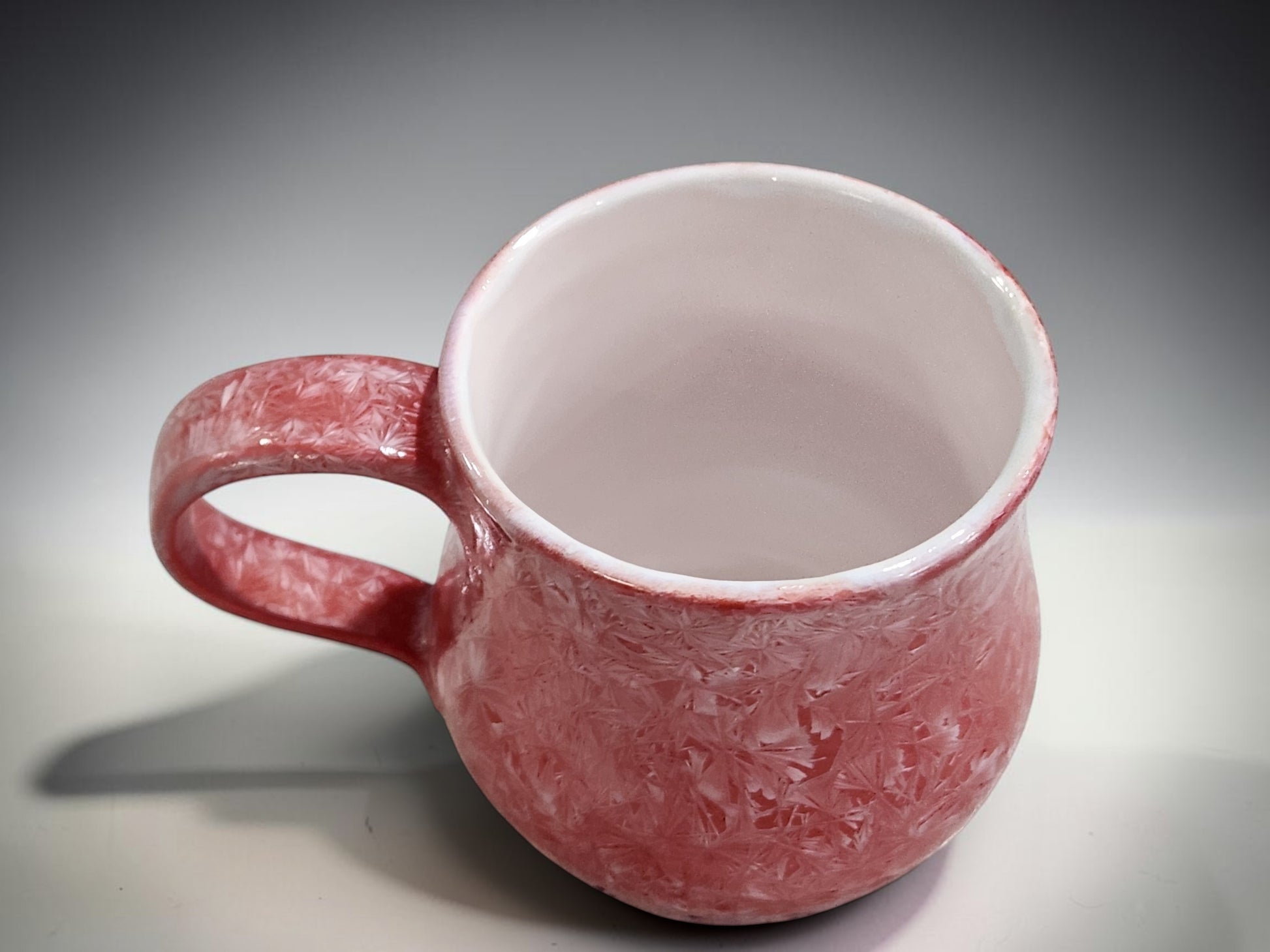 Wheel-thrown 300 ml porcelain coffee mug with handmade handle