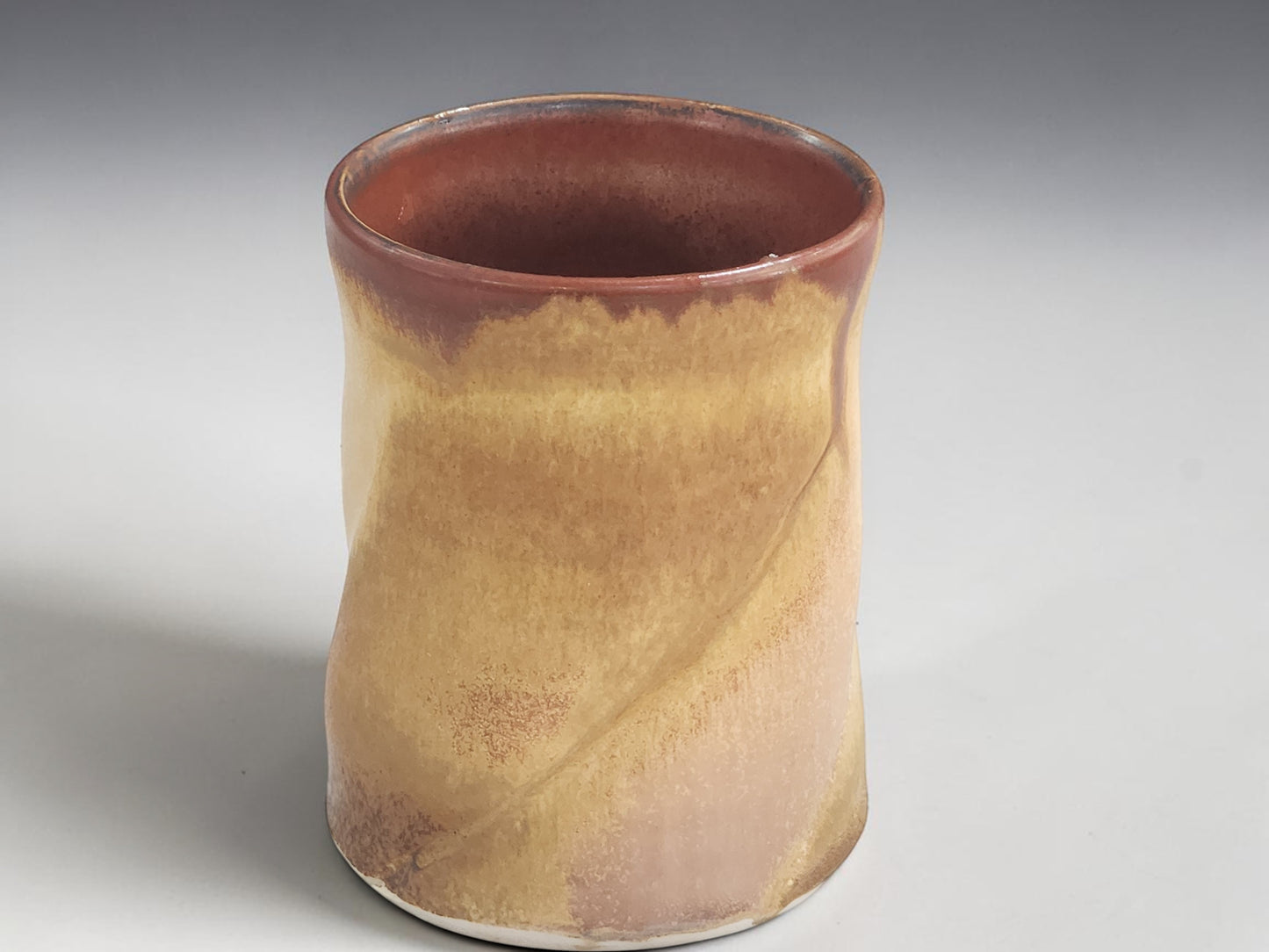Rustic handmade pottery mug with earthy Australian landscape inspired glaze