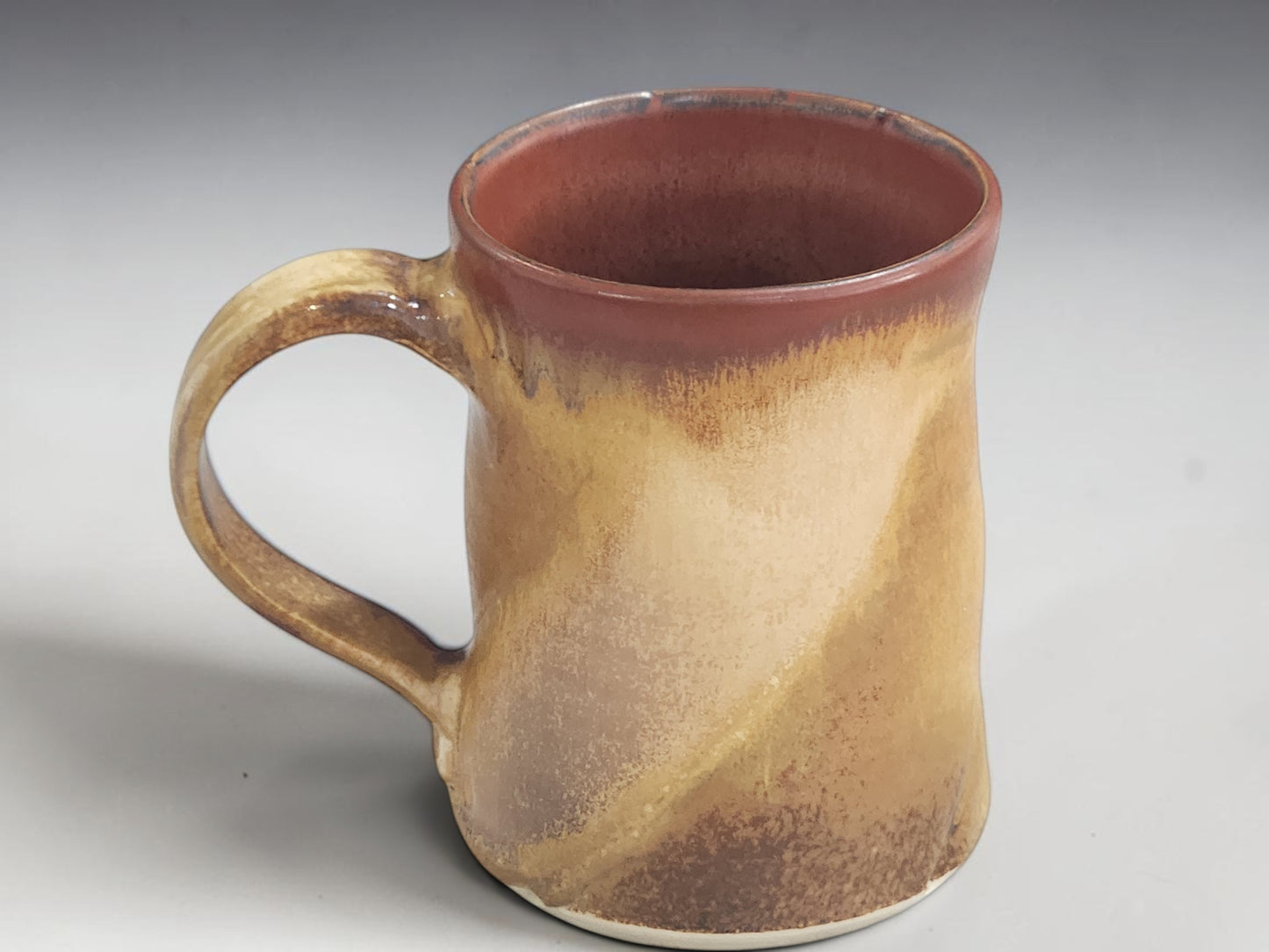 Unique handmade stoneware mug with warm brown and oatmeal glaze