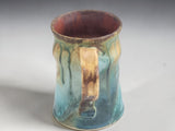 Rustic handmade coffee mug from Buxton Pottery with unique turquoise and amber glaze finish.