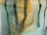 Close-up of the Bush Creek Earth glaze showing layered turquoise, amber and iron brown colours.