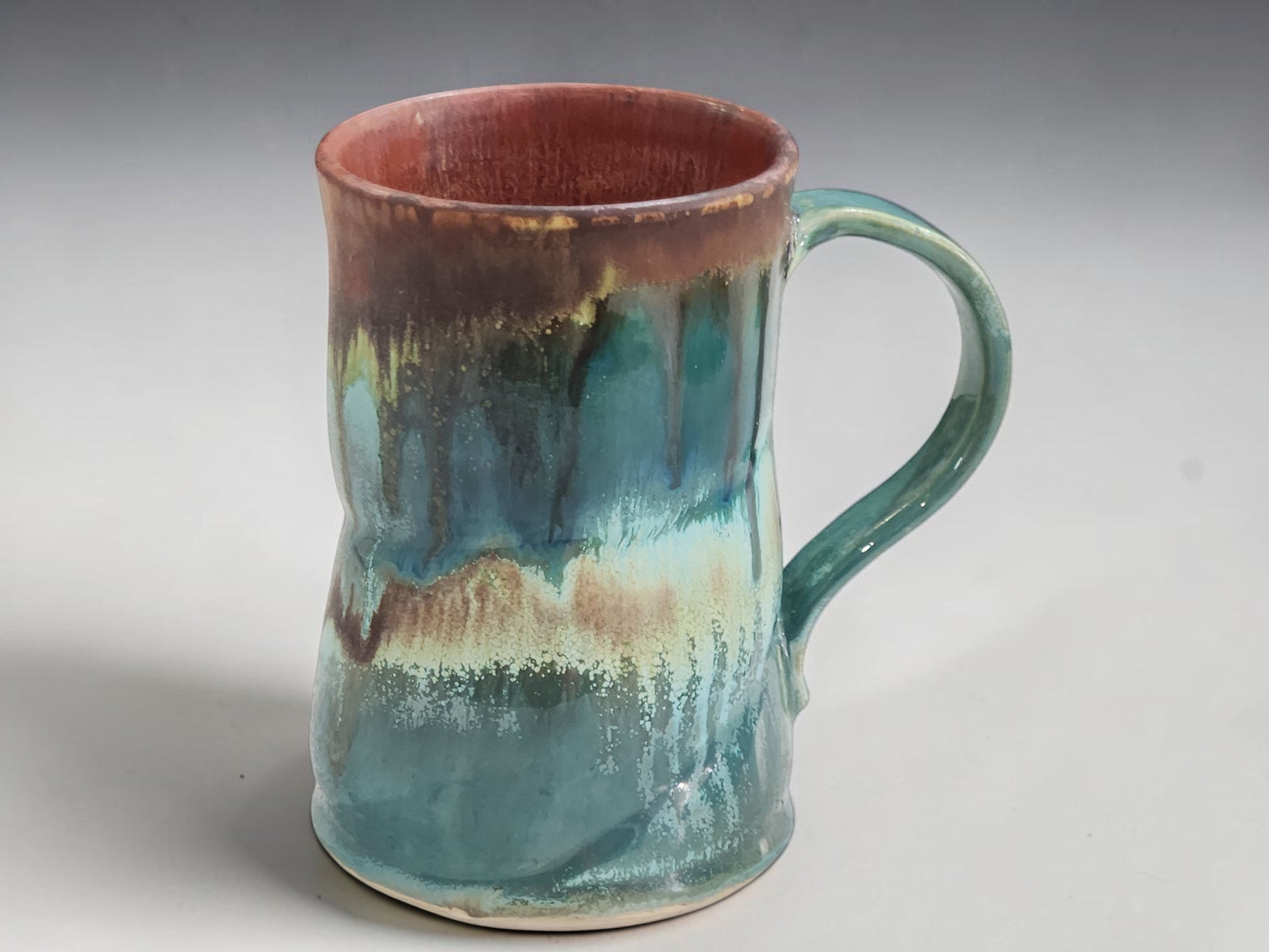 Handmade Australian stoneware mug with comfortable curved handle and unique glaze.