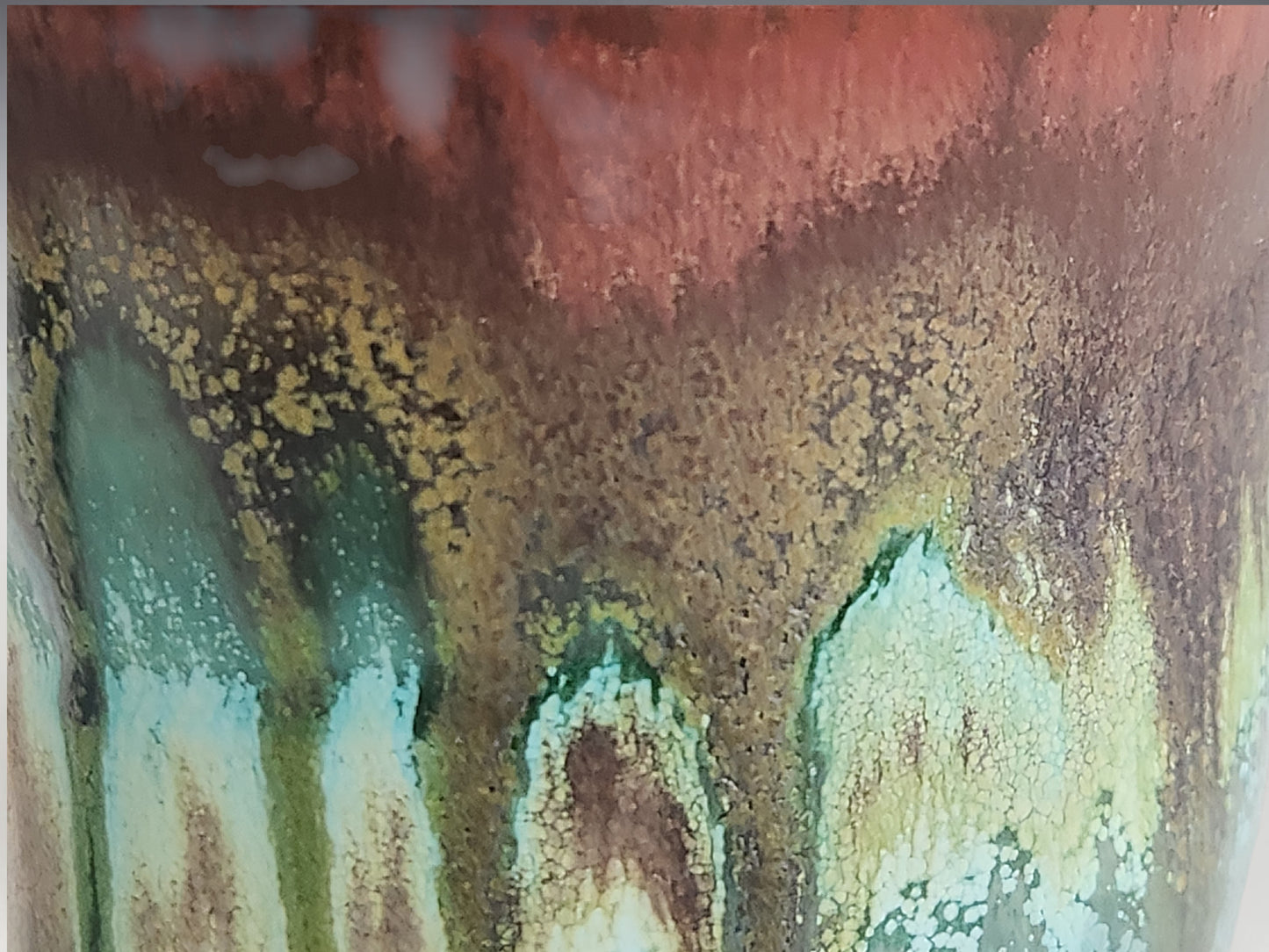 Close-up of the Bush Creek Earth glaze showing organic glaze movement and layered colours.
