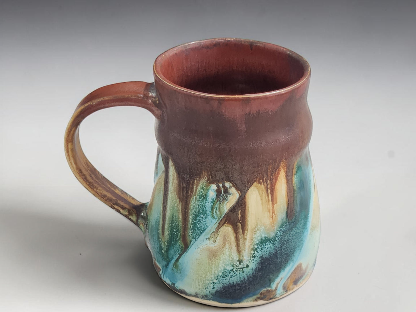 Handmade Melbourne pottery mug with organic wheel-thrown form and unique glaze movement