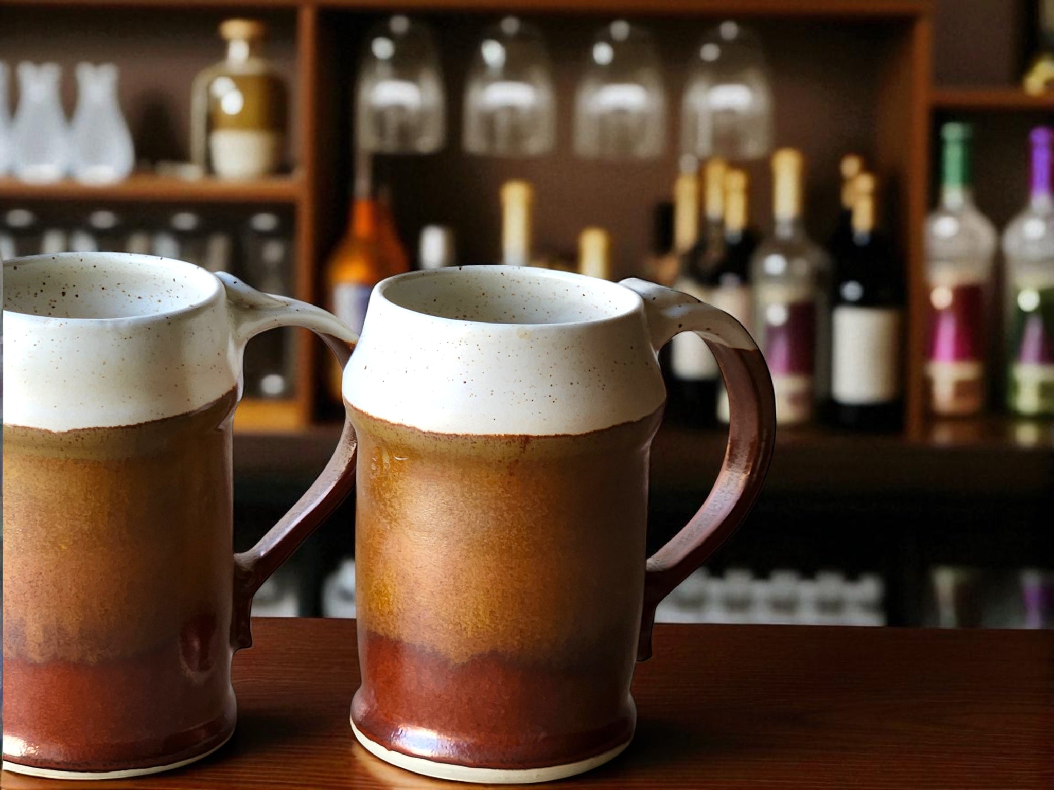 Handmade ceramic beer stein with speckled cream and red-brown glaze