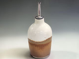Handmade ceramic oil cruet with stainless steel pourer, created in Melbourne using traditional pottery techniques and durable stoneware clay.