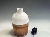 Australian handmade pottery oil bottle in cream and earthy brown glaze, combining practical kitchen storage with artisan craftsmanship.
