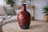 Handmade crystalline glaze ceramic vase (18cm) in red with blue crystals, styled on a coffee table in a modern living room, Melbourne Australia