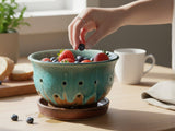 Handmade ceramic berry bowl with drainage holes and saucer