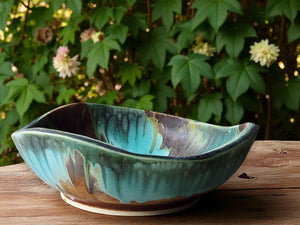 Handmade ceramic serving bowl with green and brown glaze