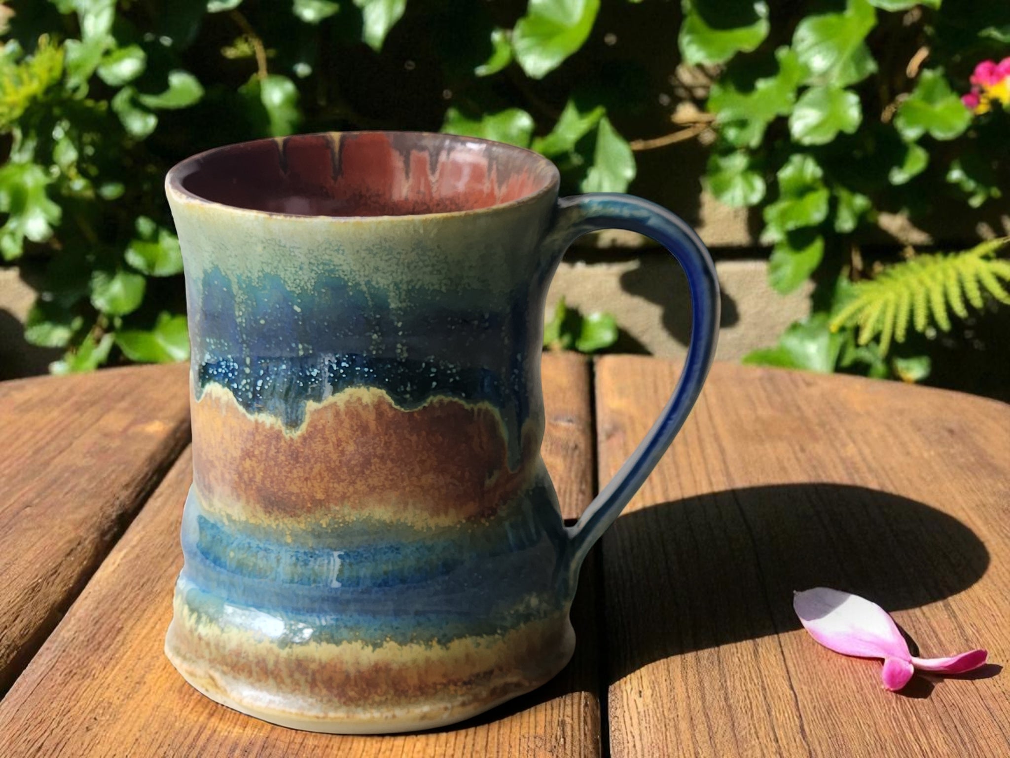 Handmade ceramic mug with layered rust and blue glaze