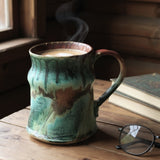 Handmade pottery mug with turquoise and brown glaze