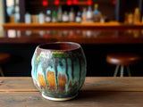 Handmade yunomi tea cup in rustic turquoise and brown glaze