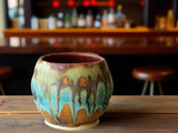 Rustic pottery yunomi with layered turquoise moss and light brown glaze