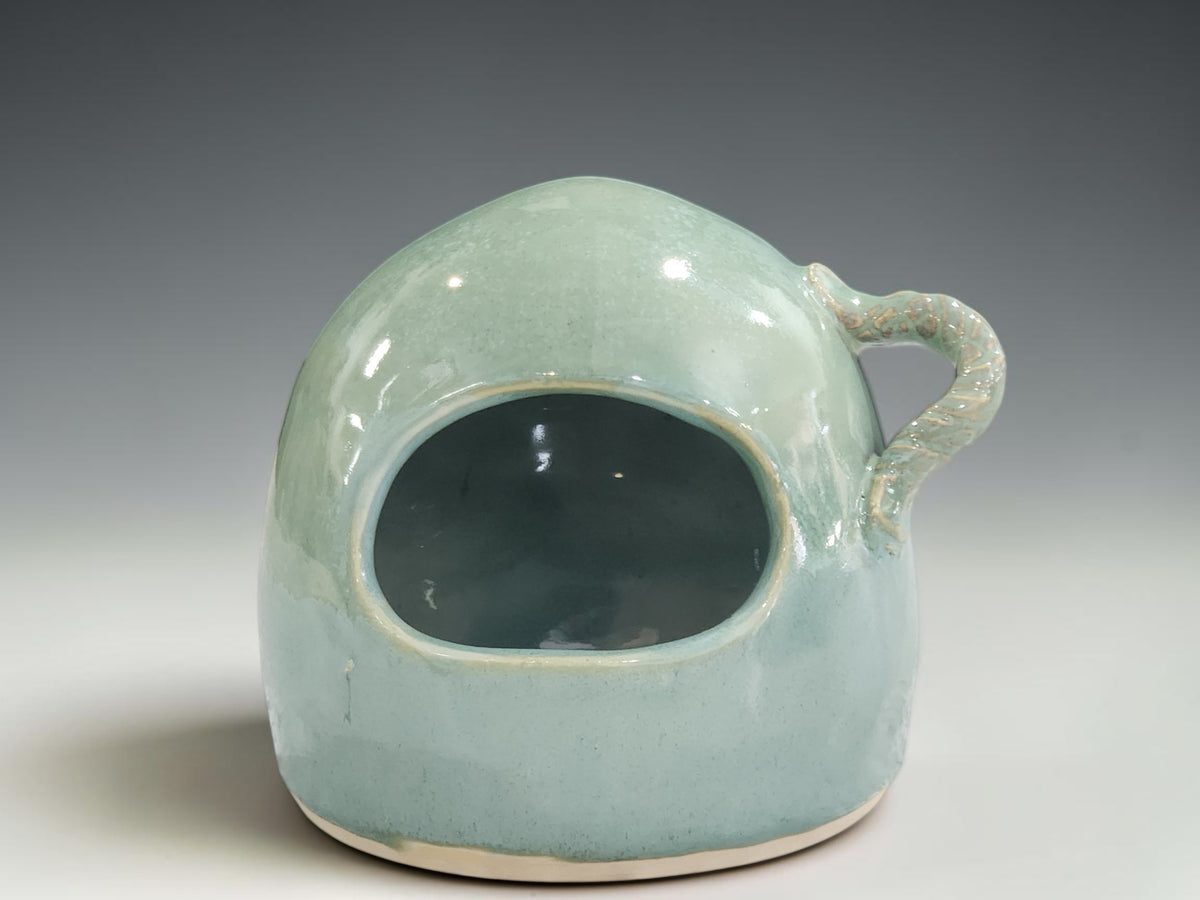 handmade pottery salt pig showing soft seafoam green glaze and glossy surface variation