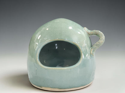 handmade pottery salt pig showing soft seafoam green glaze and glossy surface variation