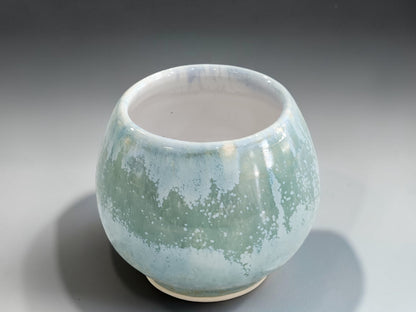 Handleless ceramic whisky sipper in pale green mottled glaze