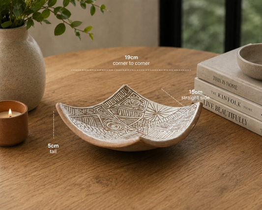 Hero image of handcrafted terracotta bowl-plate displayed on timber table with modern home décor accents