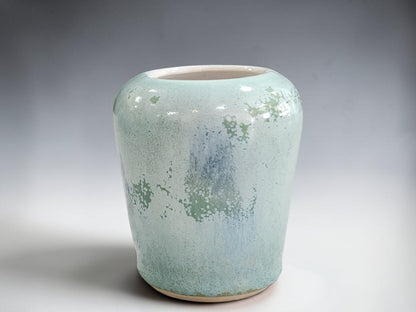 Small green bud vase measuring 7.5 cm tall