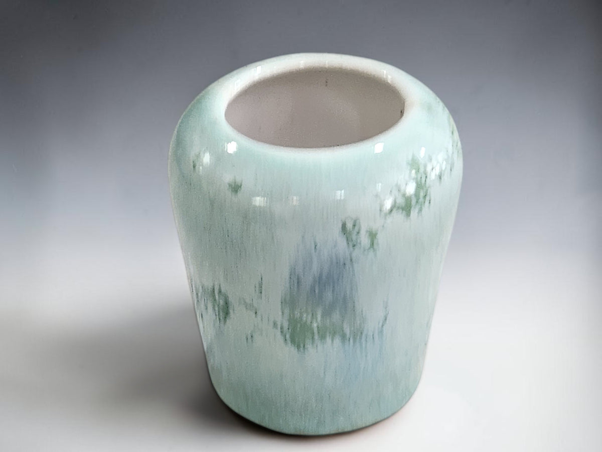 Handmade ceramic flower vase with rounded shoulders and a wide opening