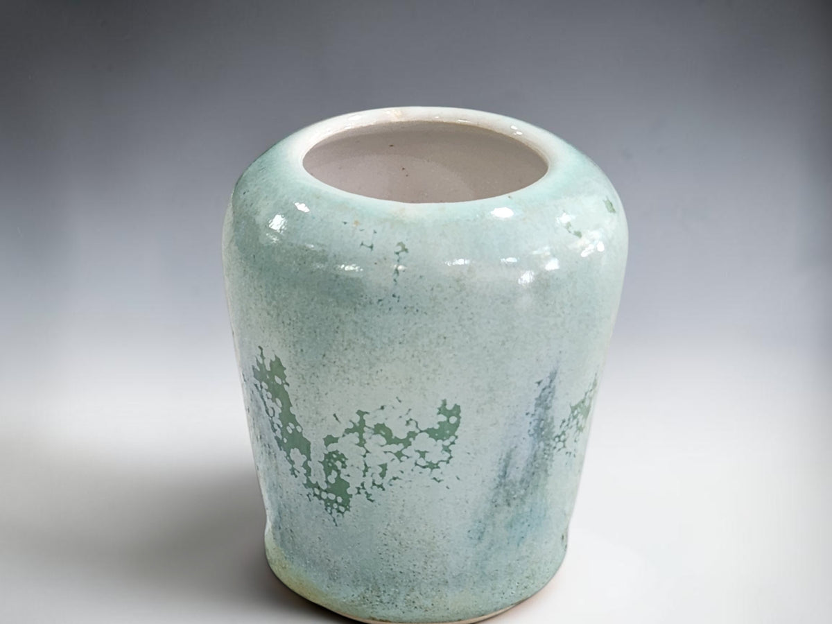 Small blue-green stoneware bud vase shown from the front