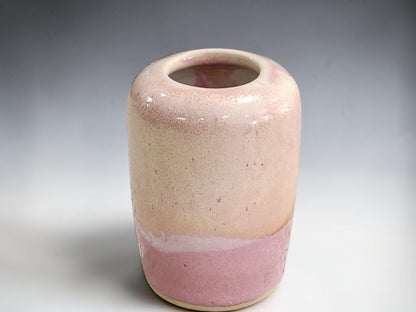 Dusty-pink ceramic bud vase shown from the front