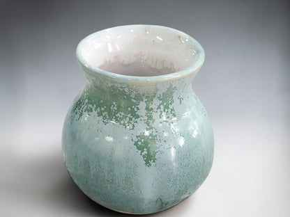 Small green flower vase with a softly flared rim