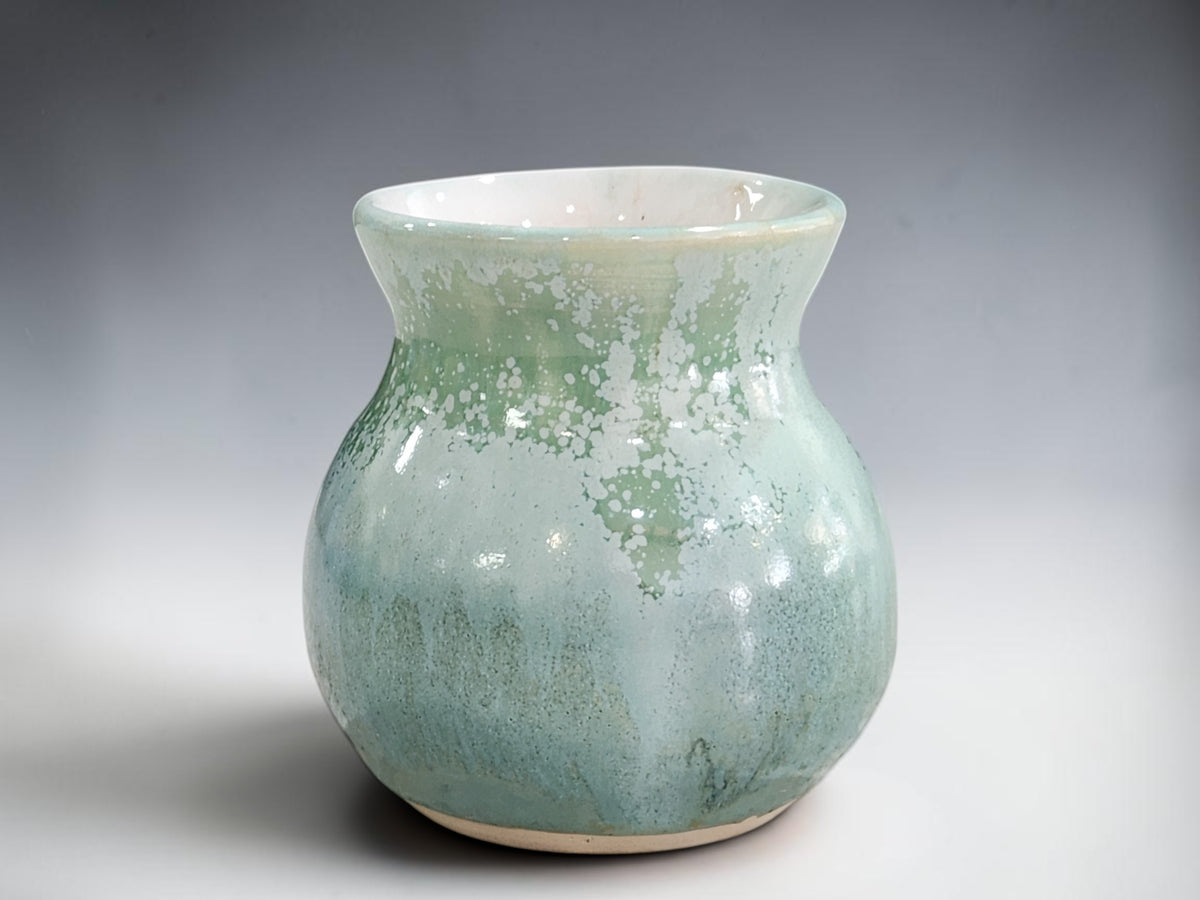 Handmade rounded bud vase measuring 9 cm tall