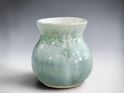 Handmade rounded bud vase measuring 9 cm tall