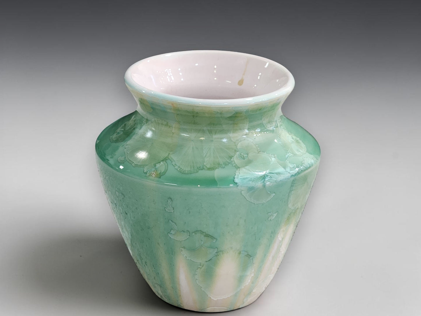 Front view of handmade soft green crystalline bud vase