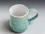 Handmade ceramic mug with pale green crystalline flower patterns