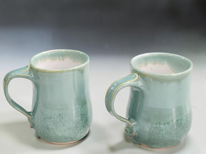 Handmade spearmint green pottery mugs with drippy glaze detail