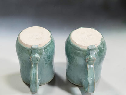Close-up of drippy glaze around the base of handmade stoneware mugs