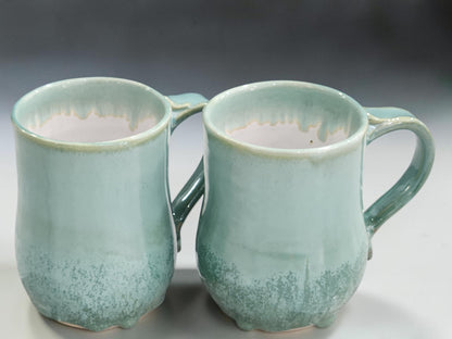 Handmade 450 ml and 500 ml pottery mugs in soft green glaze